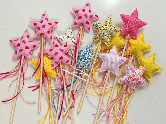 A bunch of fabric star wands with long satin ribbons
